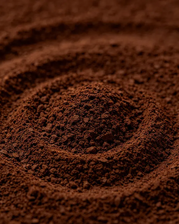 Macro photography of recycled coffee grounds texture, symbolizing InnoSelect’s proactive milestone reporting and visual transparency in global supply chain management.