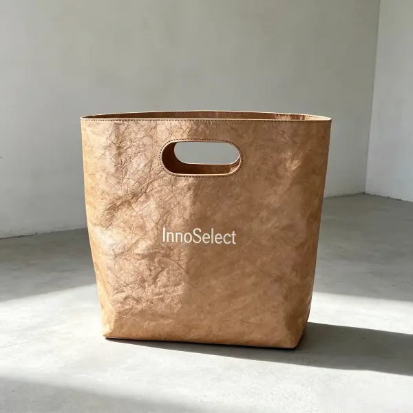 Minimalist brown washable paper tote bag with die-cut handles and debossed custom logo for trade shows.