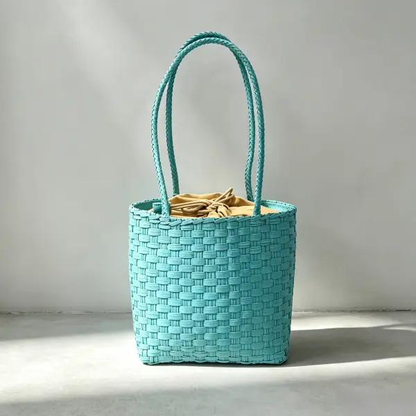 Bright turquoise woven paper mesh tote bag with lightweight handles for seasonal promotional giveaways.