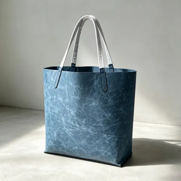 Eco-friendly vintage blue washable paper tote bag featuring natural leather-like texture and shoulder straps.